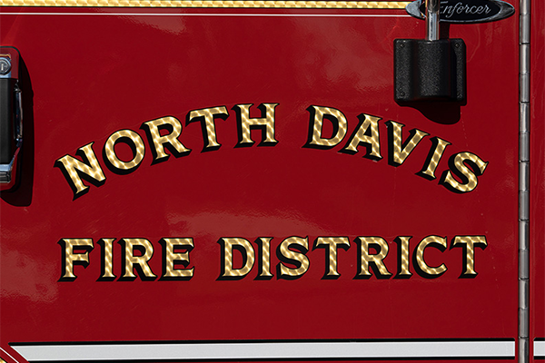 A gold leaf graphic on North Davis Fire District's red fire truck door.