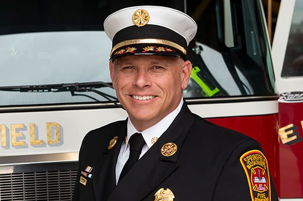 The Springfield Fire and Emergency Serivces Fire Chief posed in front of a fire truck.