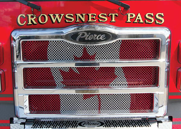 The front grille of a Pierce fire truck with a Canadian flag design.