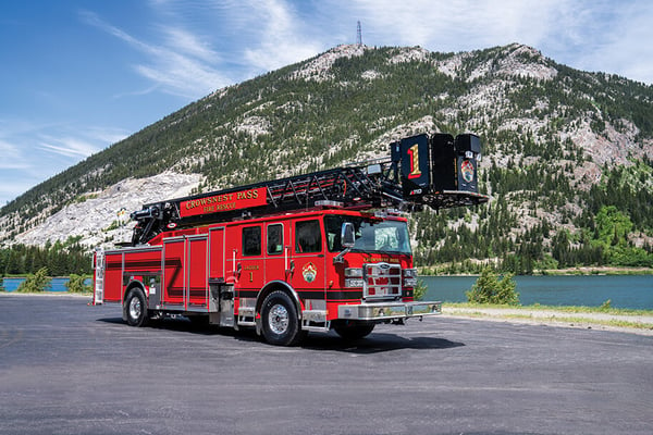 Crowsnest Pass Fire Rescues Enforcer 110 Ascendant Heavy-Duty Platform parked in front of a lake and a mountain.