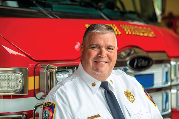 The South Windsor Fire Department Chief posed in front of a Pierce fire truck.