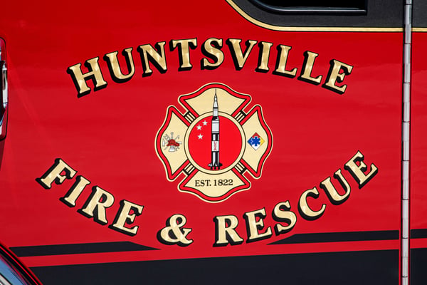 The graphic on the door of Huntsville Fire & Rescues fire truck with a rocket in the middle of the patch.