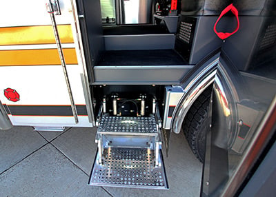 Silver fold down steps on a white fire truck