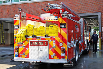 The rear end of Portland Fire & Rescue’s Engine 1 electric fire truck is seen pulling into the fire station bay. 