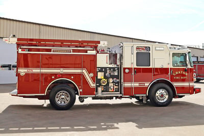 The red and white Type 1 WUI engine from Graton Fire Department is parked showing the passenger side and the unique ladder configuration. 