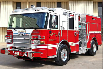 A red and white wildland apparatus is parked on an angle highlighting the cab. 