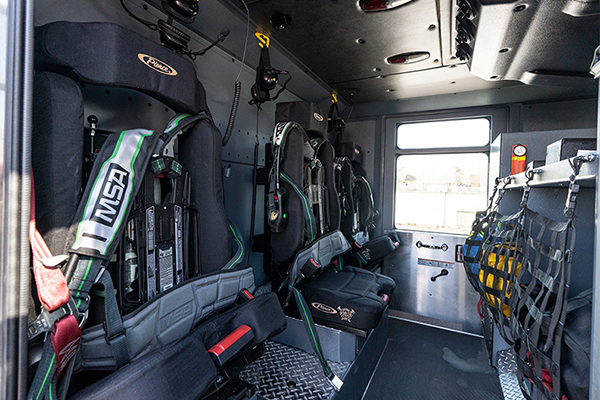 The inside of a fire trucks crew cab showing seats for firefighters.