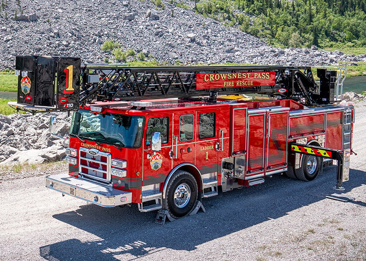 The driver’s side of an Enforcer 110' Ascendant Heavy-Duty Platform parked in front of a mountain.