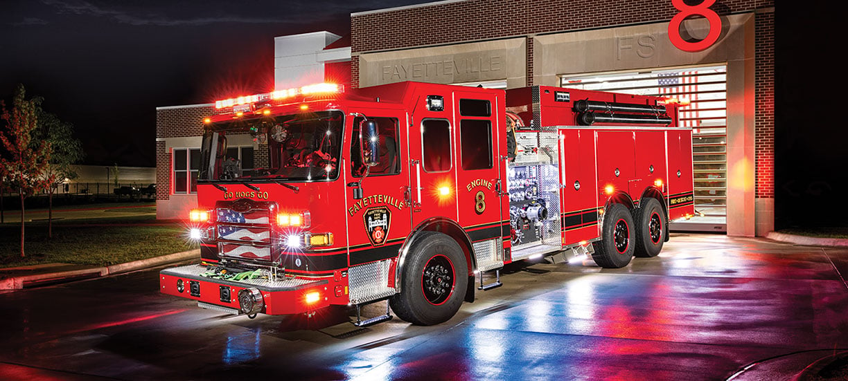 Fayetteville Fire Departments Pierce Enforcer Custom Dry-Side Tanker parked in front of their fire station at night.